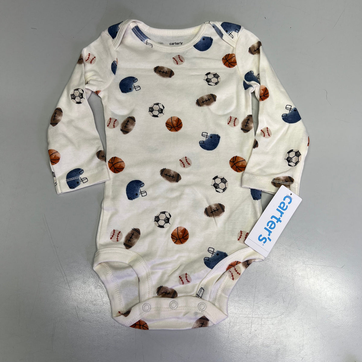Baby boy white patterned long-sleeve bodysuit with sports icons.