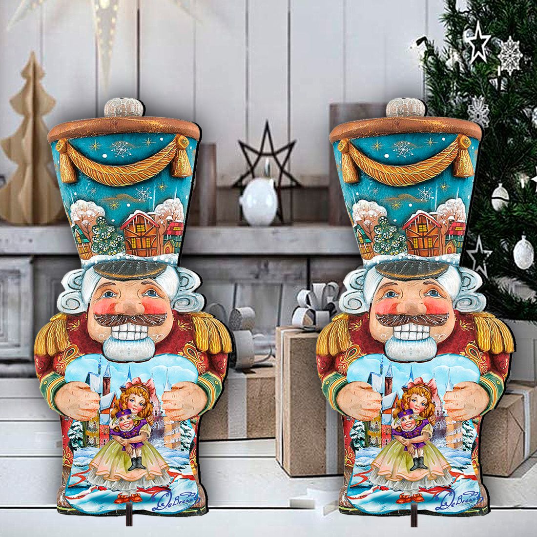 Pair of painted nutcracker holiday yard decorations with blue tops, red coats, holding dolls
