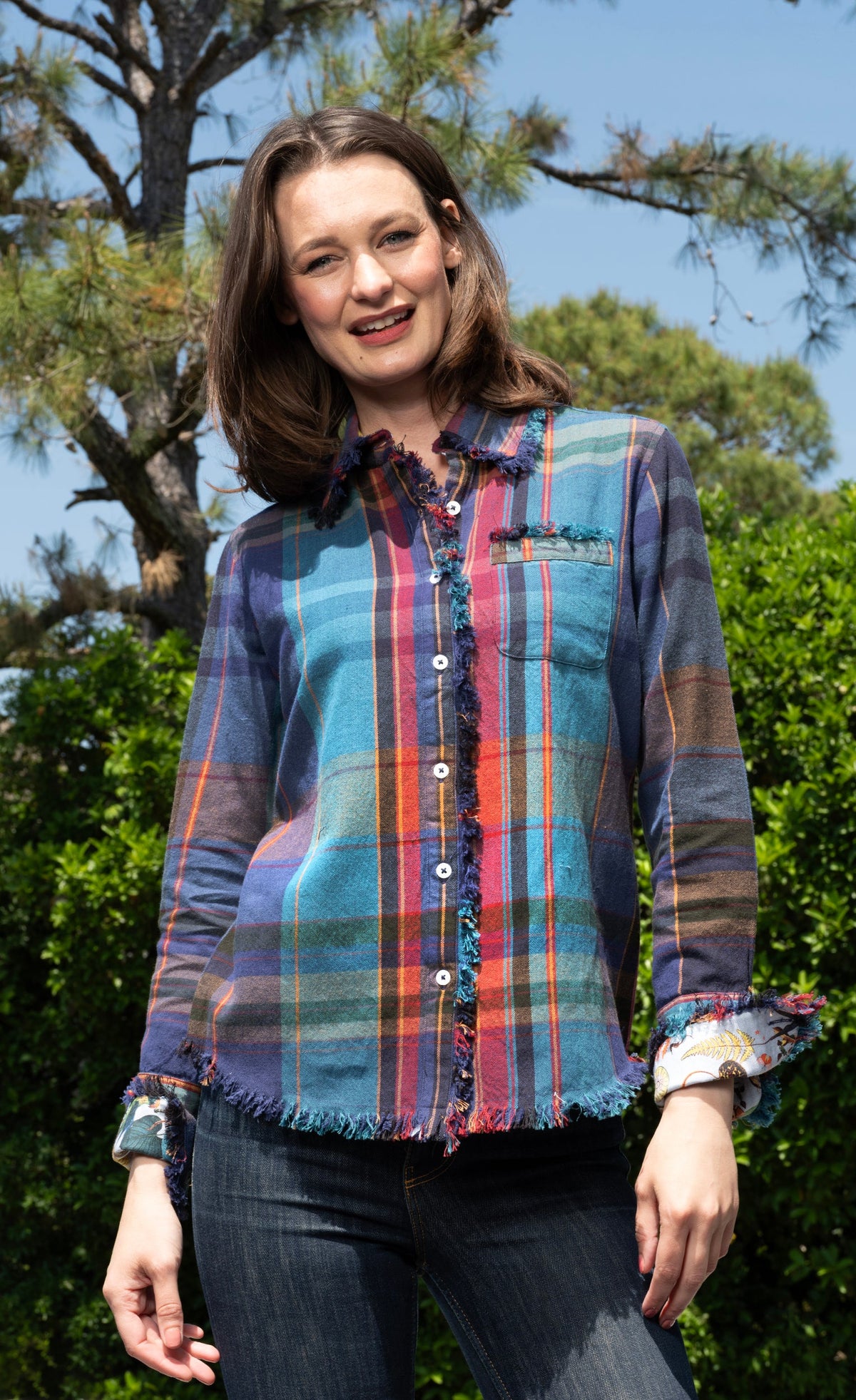 Women's blue, teal, violet plaid button-front top with ruffled collar and chest pocket