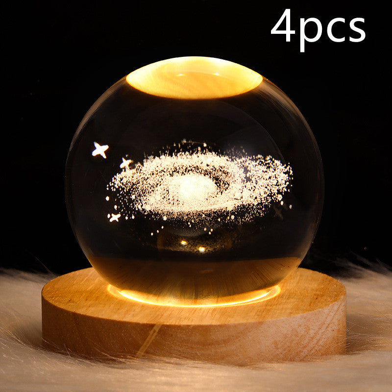 Crystal ball LED night light with glowing galaxy swirl on round wooden base