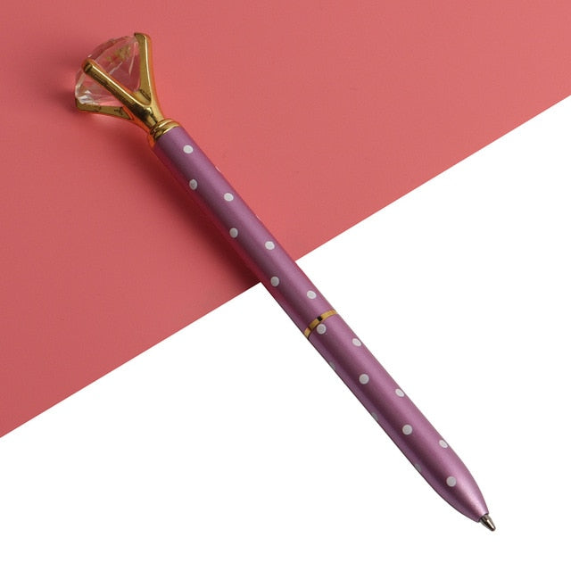 Purple ballpoint pen with white dots and faceted gold gem top, metal tip