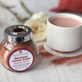 Beetroot cacao latte mix bottle with metal lid and a small latte cup