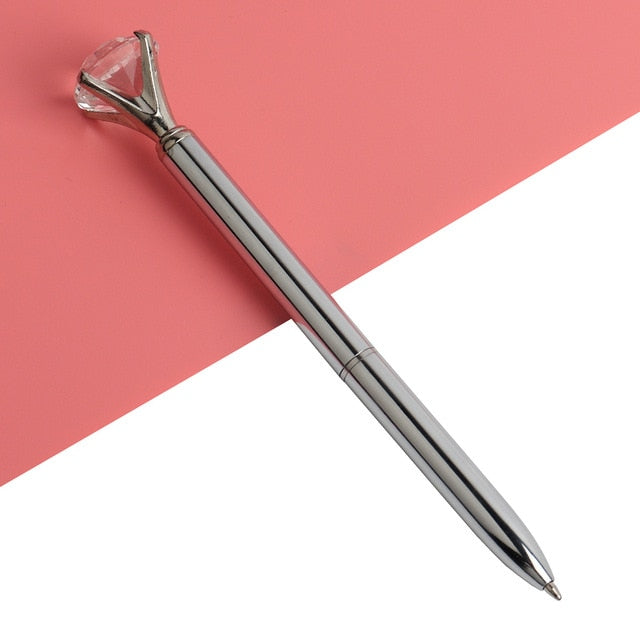 Steel gray ballpoint pen with faceted gold gem top and metal ballpoint tip
