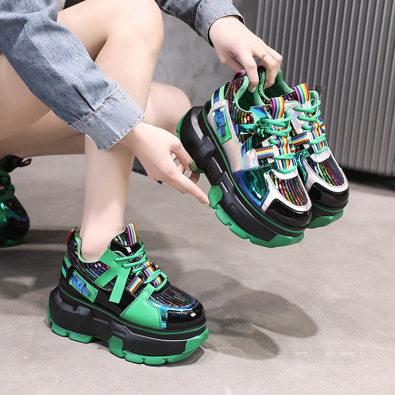Green lace-up chunky sneakers with rainbow-striped laces and black platform sole