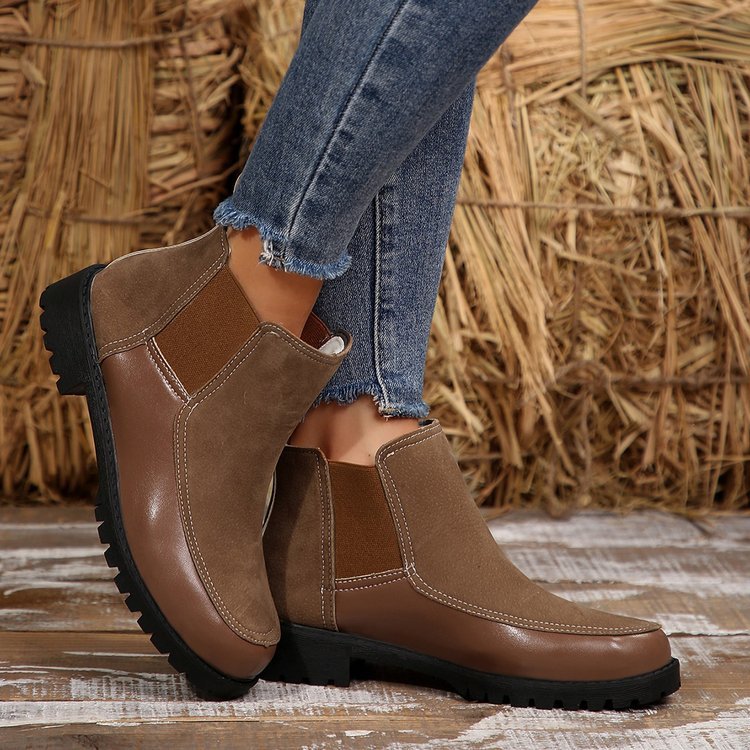 Brown platform ankle boots with side panels, stitching seams, and rugged sole