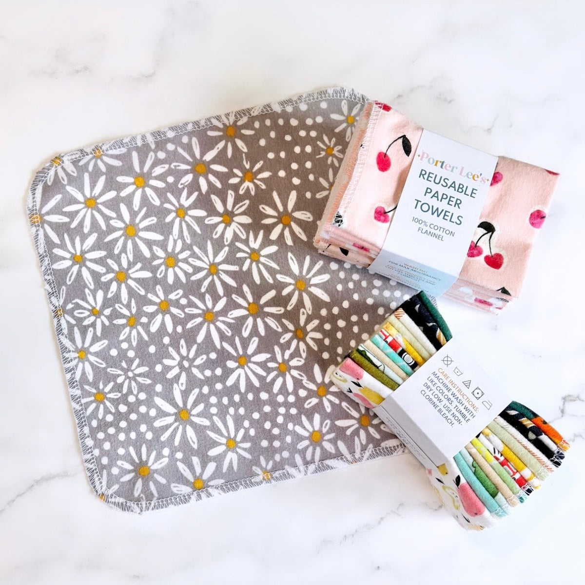 Reusable paper towels on gray daisy fabric: roll with cherry print plus colorful markers