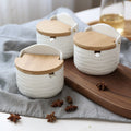 Half-round white ceramic seasoning can with light wood flip-top lid