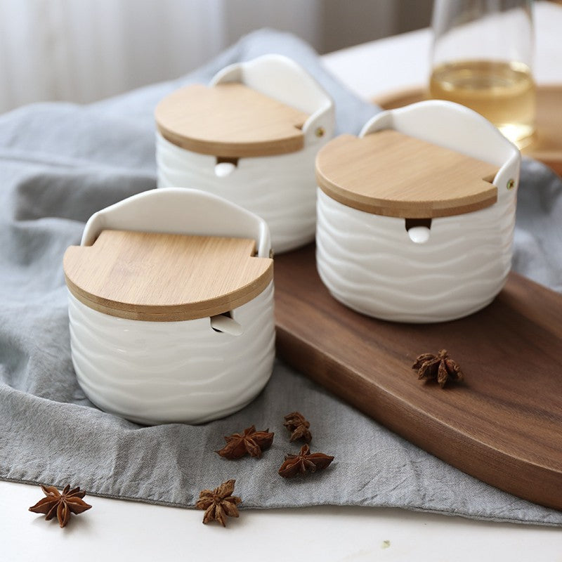 Half-round white ceramic seasoning can with light wood flip-top lid