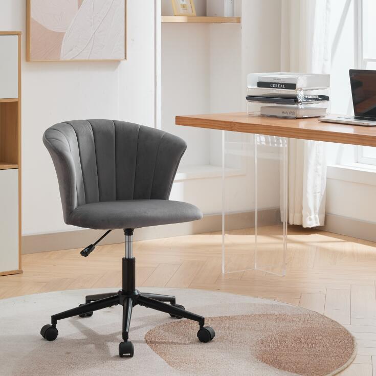 Grey velvet office chair with curved back, black base, and caster wheels