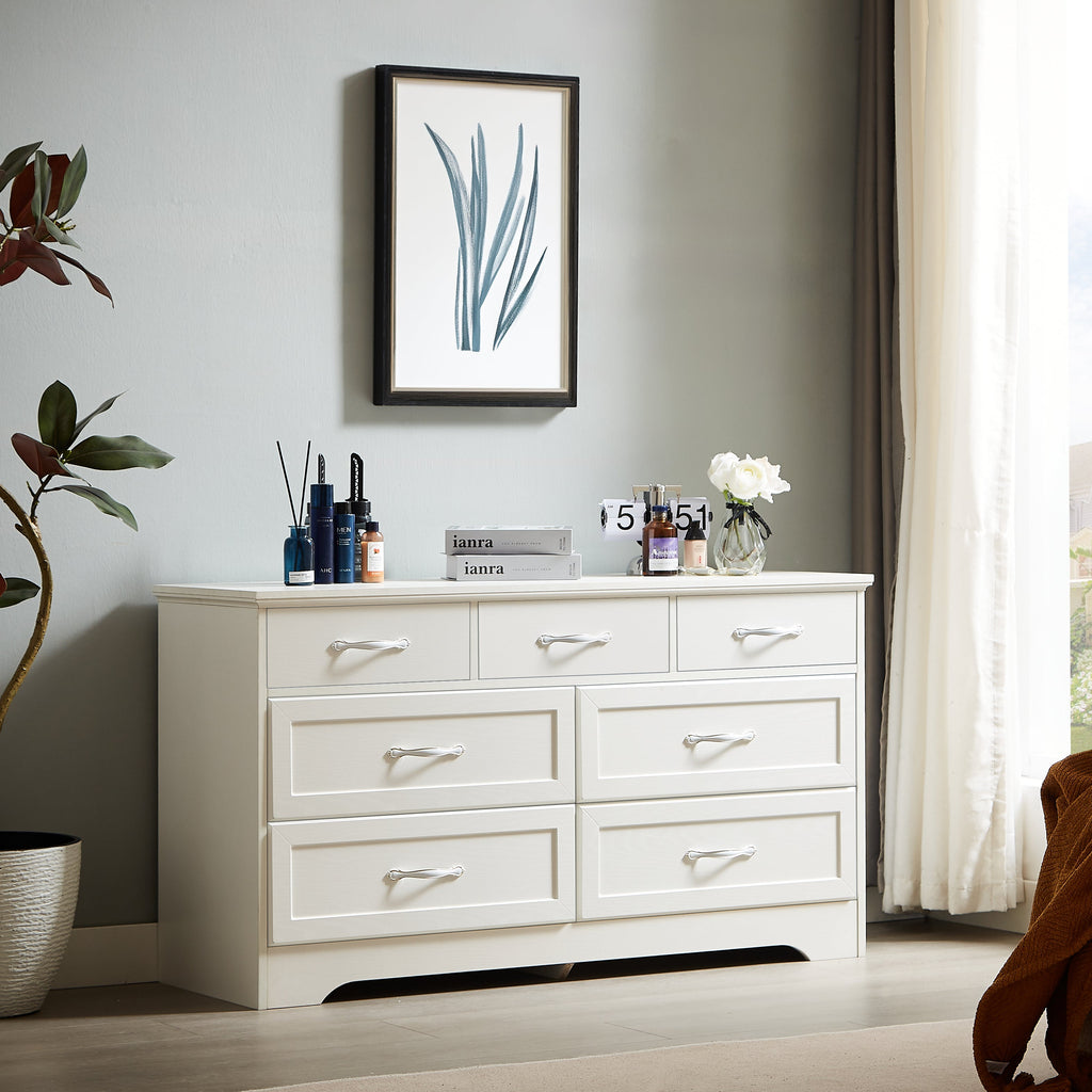 White dresser with multiple drawers and gold metal handles, modern low chest