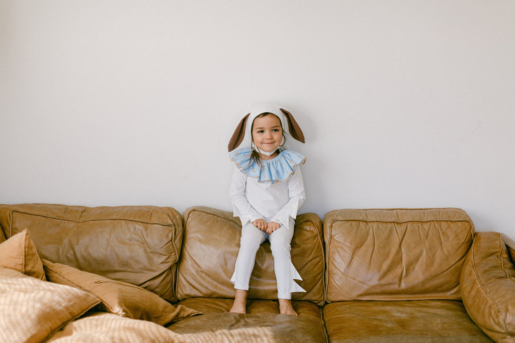White bunny costume with blue star ruffle collar and long-ear hood