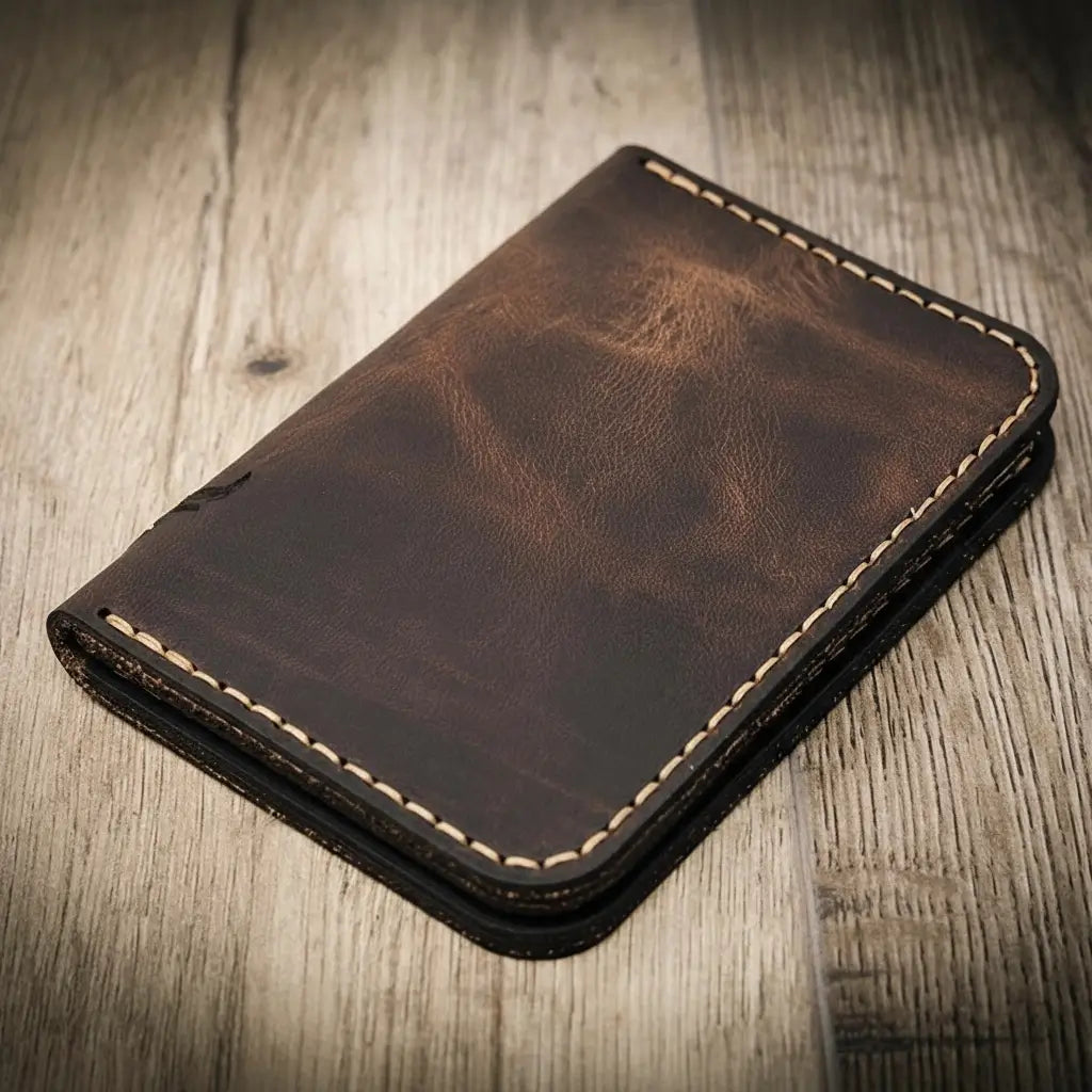 Closed dark-brown leather wallet, vertical profile with contrast edge stitching