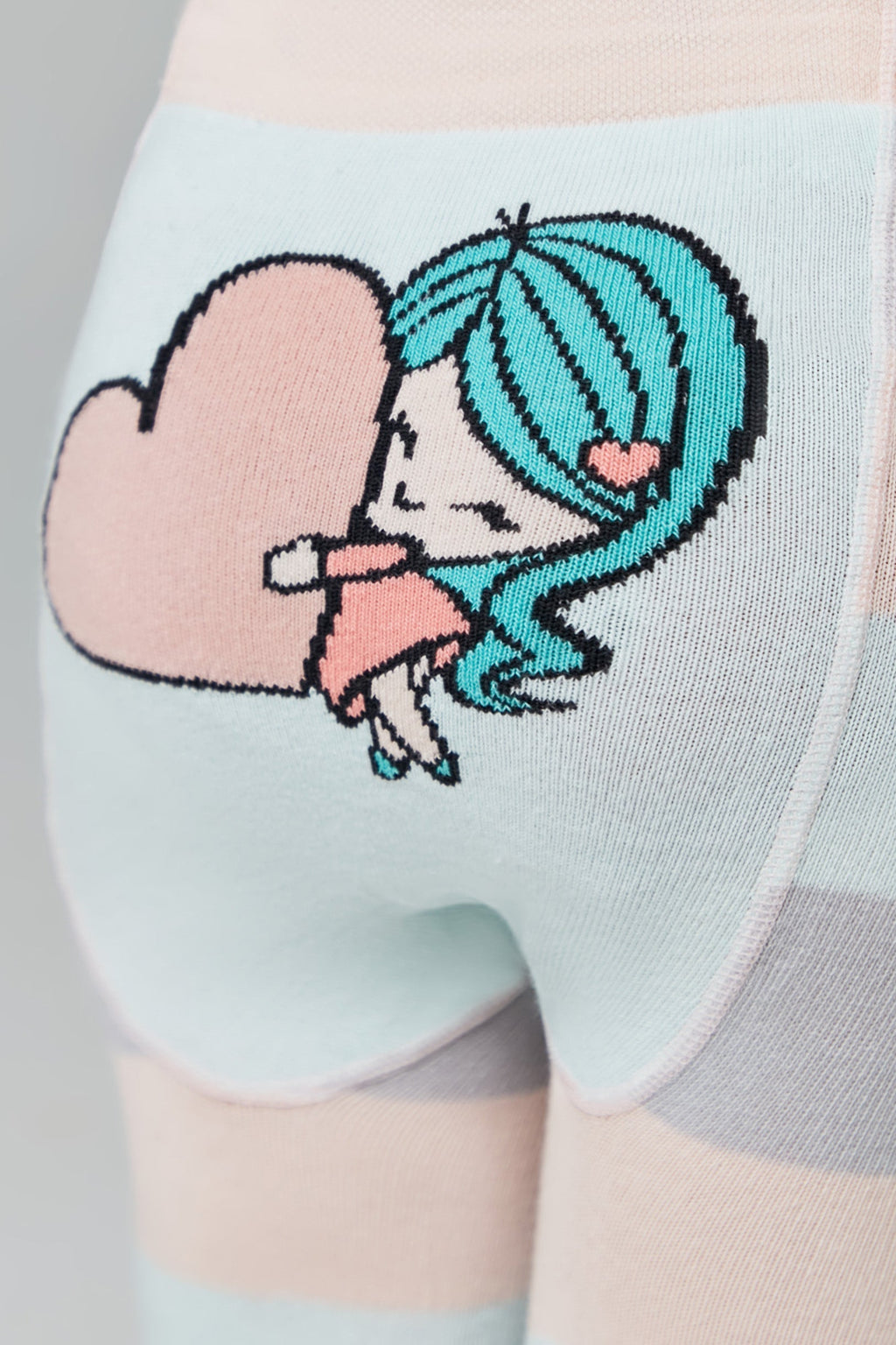 Kids cotton tights with cartoon girl and heart patch on light striped fabric