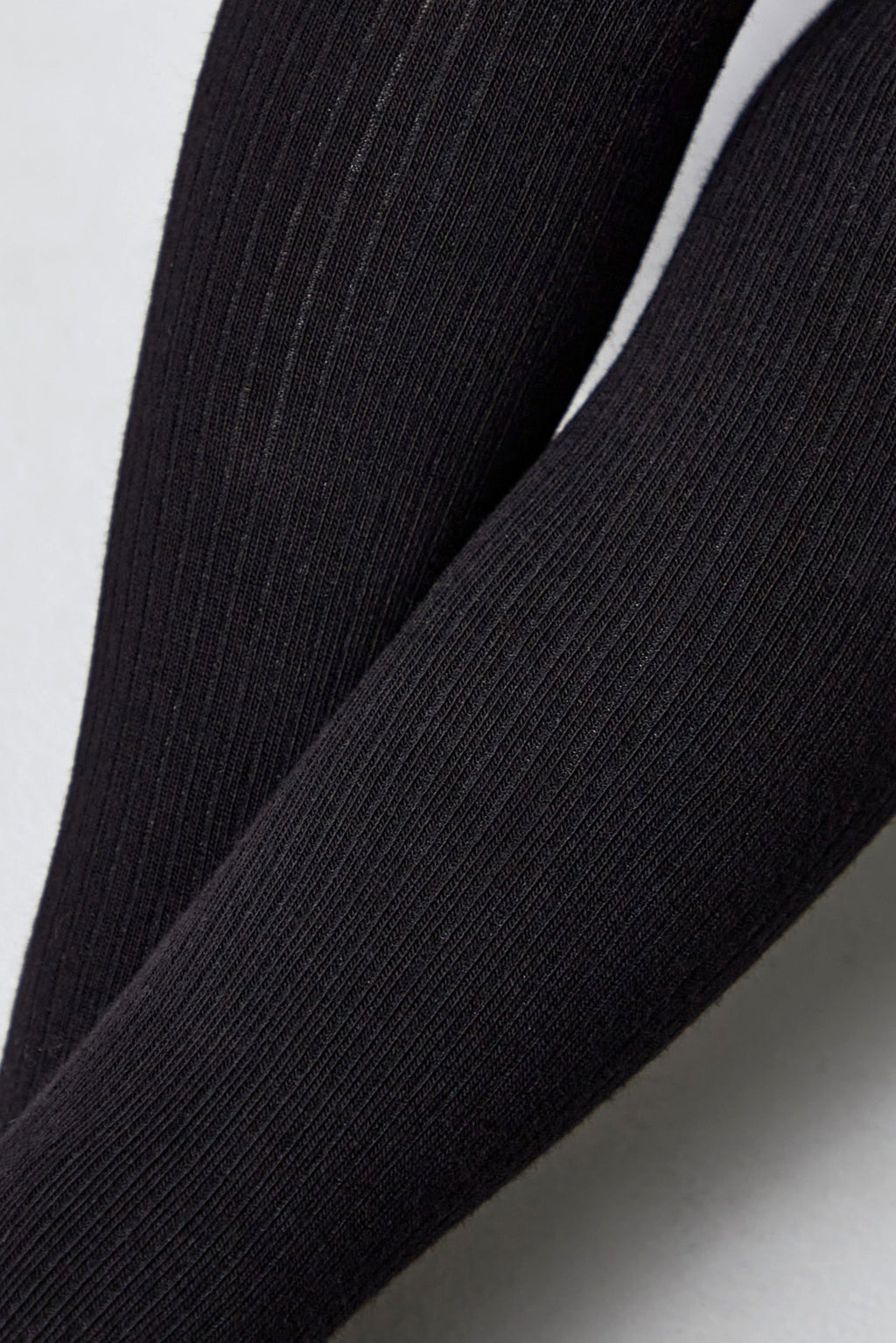 Black kids cotton tights close-up showing fine vertical knit ribs