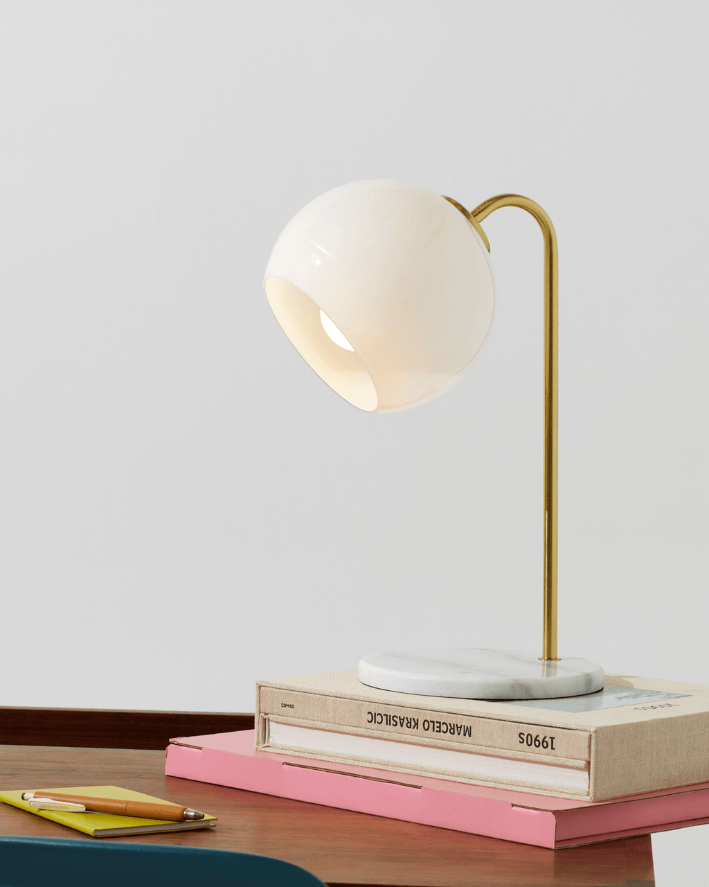 Krystal table lamp with round opal glass shade and tall gold arched stand