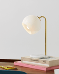 Krystal table lamp with round opal glass shade and tall gold arched stand