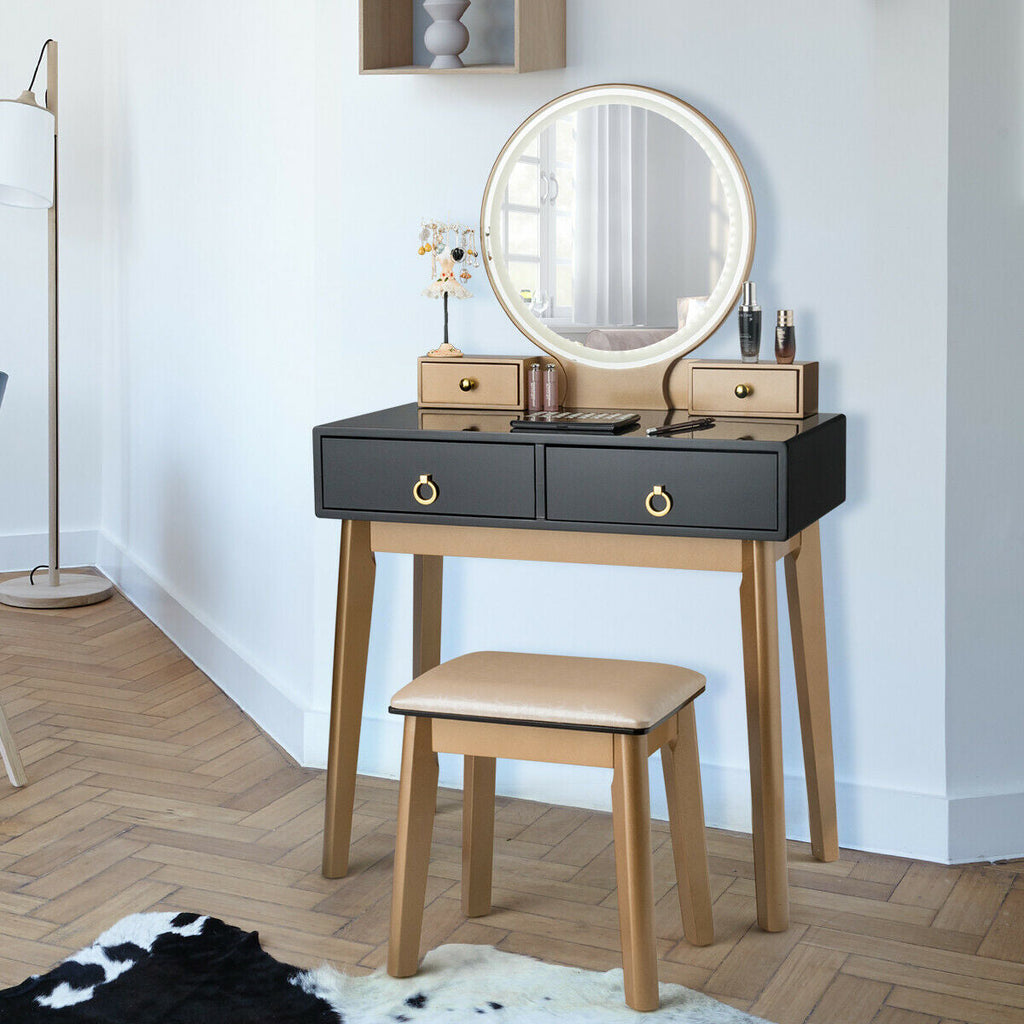 Makeup vanity table set with round illuminated mirror, black drawers, and beige stool
