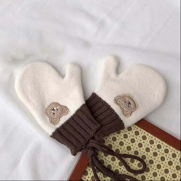 Kids winter mittens with cream tops, brown ribbed cuffs, and bear patch details