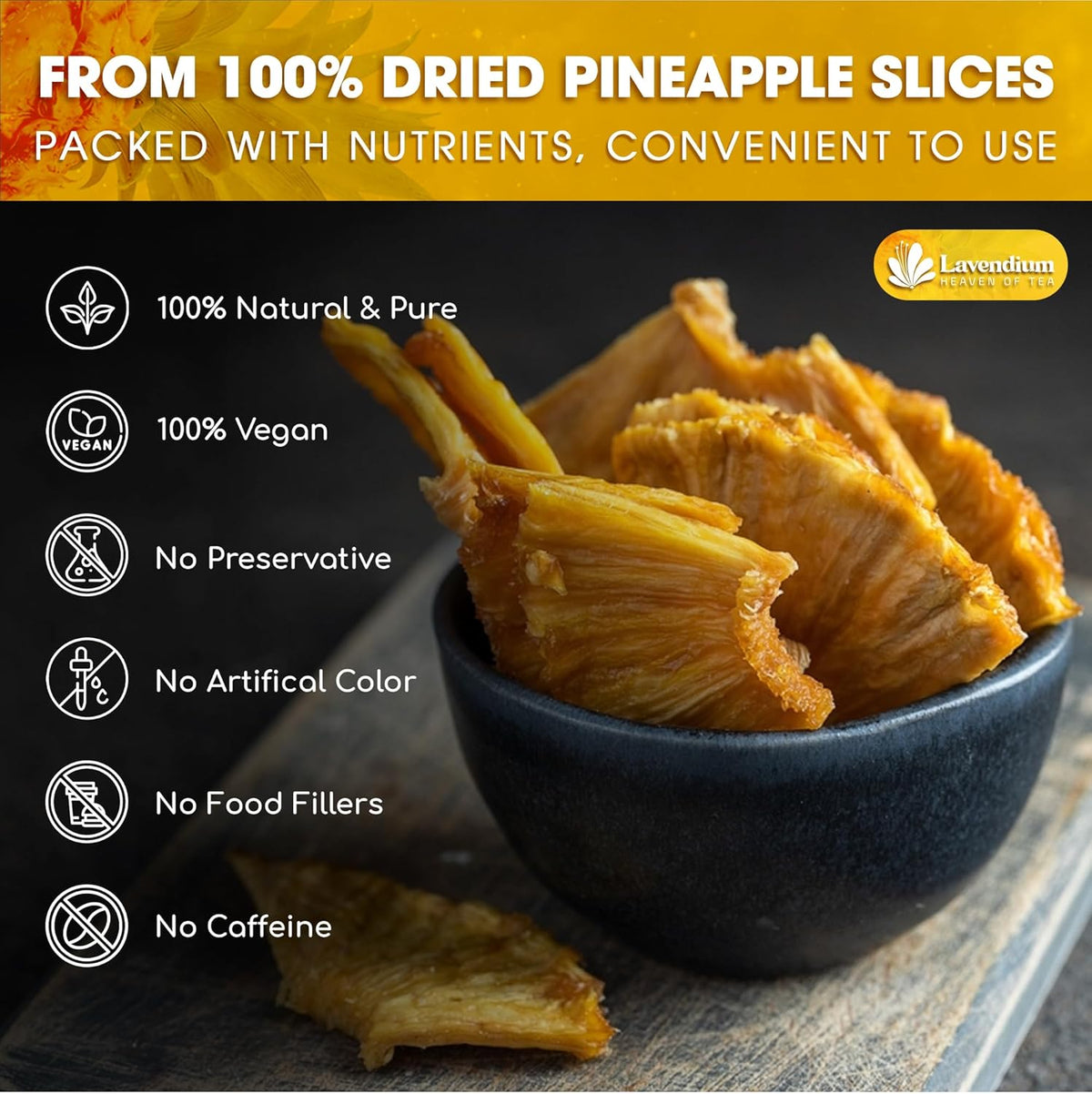 Dried pineapple slices in a dark bowl, golden pieces with visible center holes