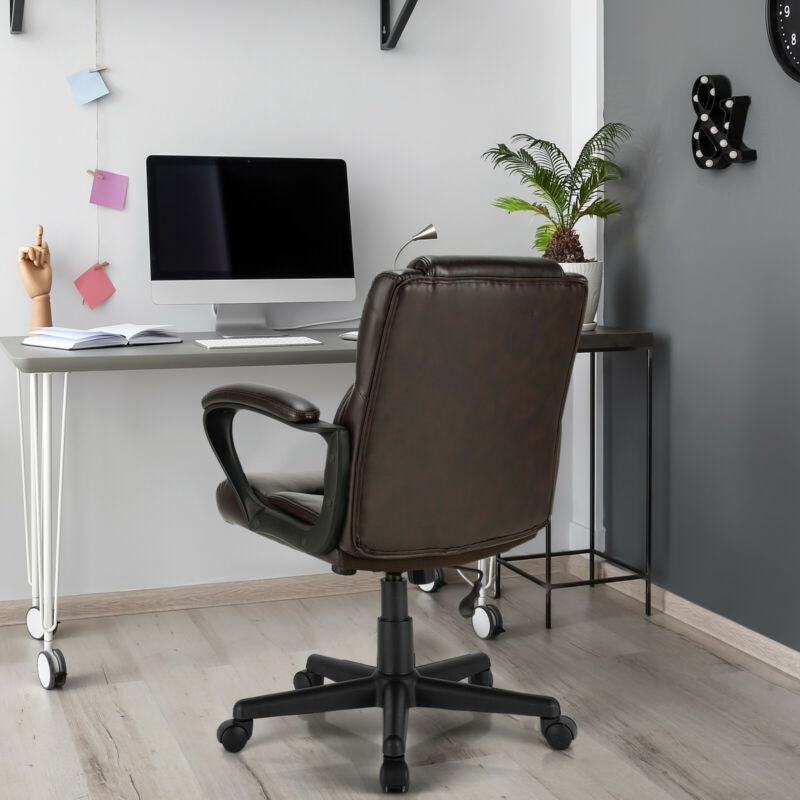 Dark leather swivel office chair with armrests and rolling base in home office setting.
