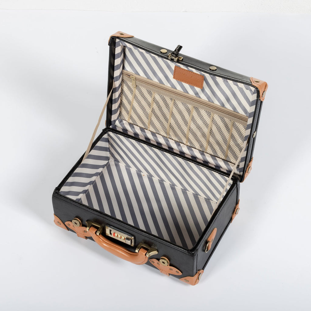 Open black suitcase with striped lining, mesh pockets, and tan leather trim