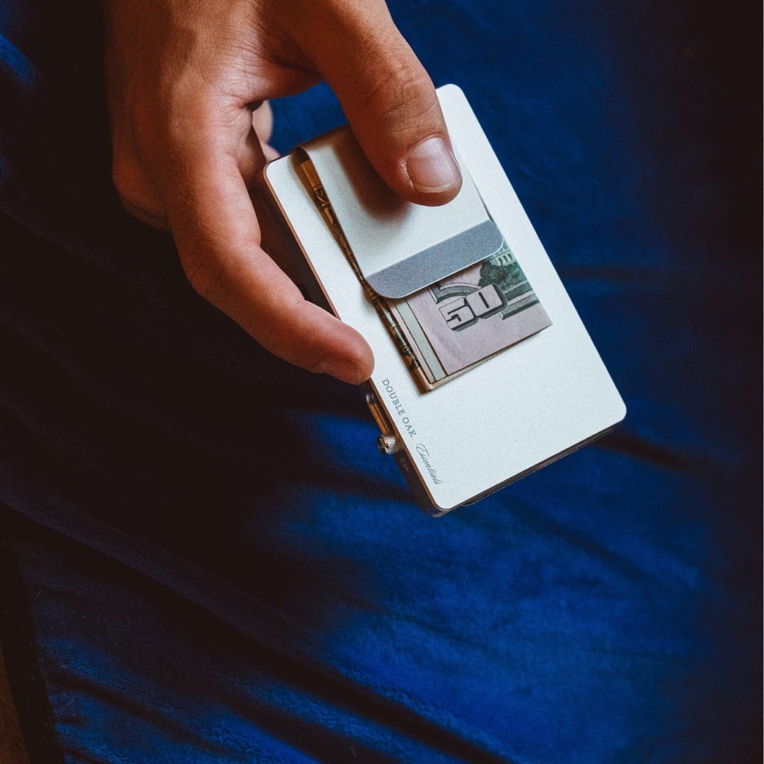 White pop-up cardholder holding bills, with a spring pop mechanism