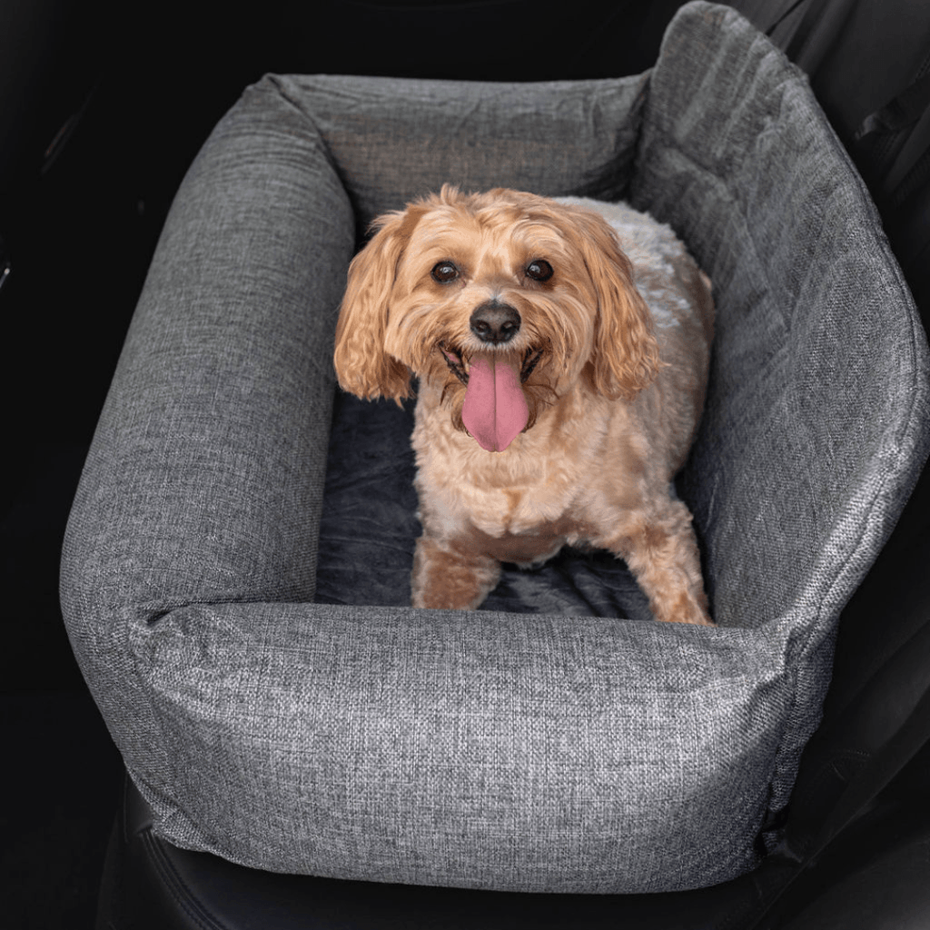 Gray dog car bed with raised bolsters and plush cushion insert.