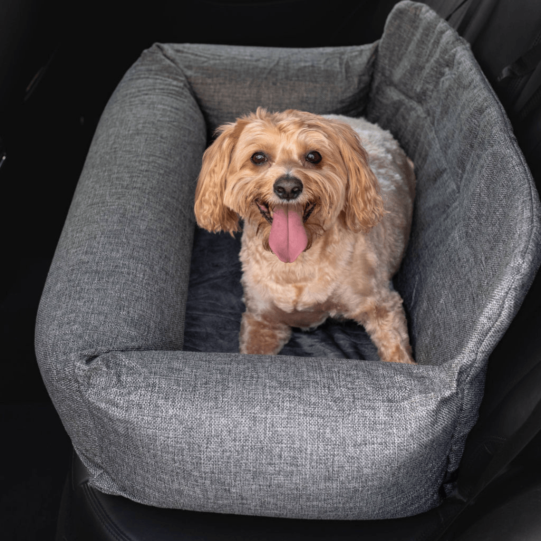 Gray dog car bed with raised bolsters and plush cushion insert.