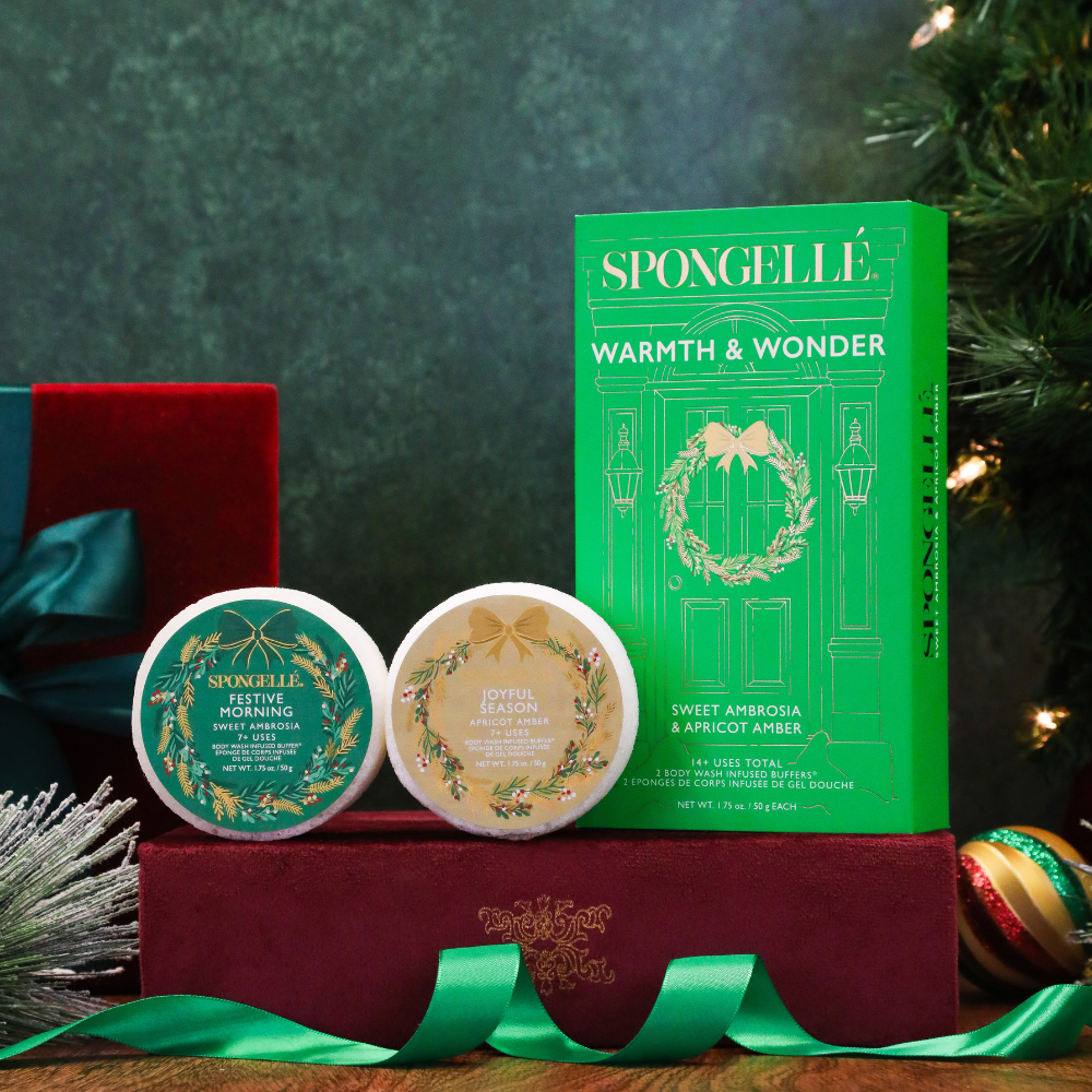 Warmth & Wonder gift set with two round body buffers, wrapped ribbon, and box