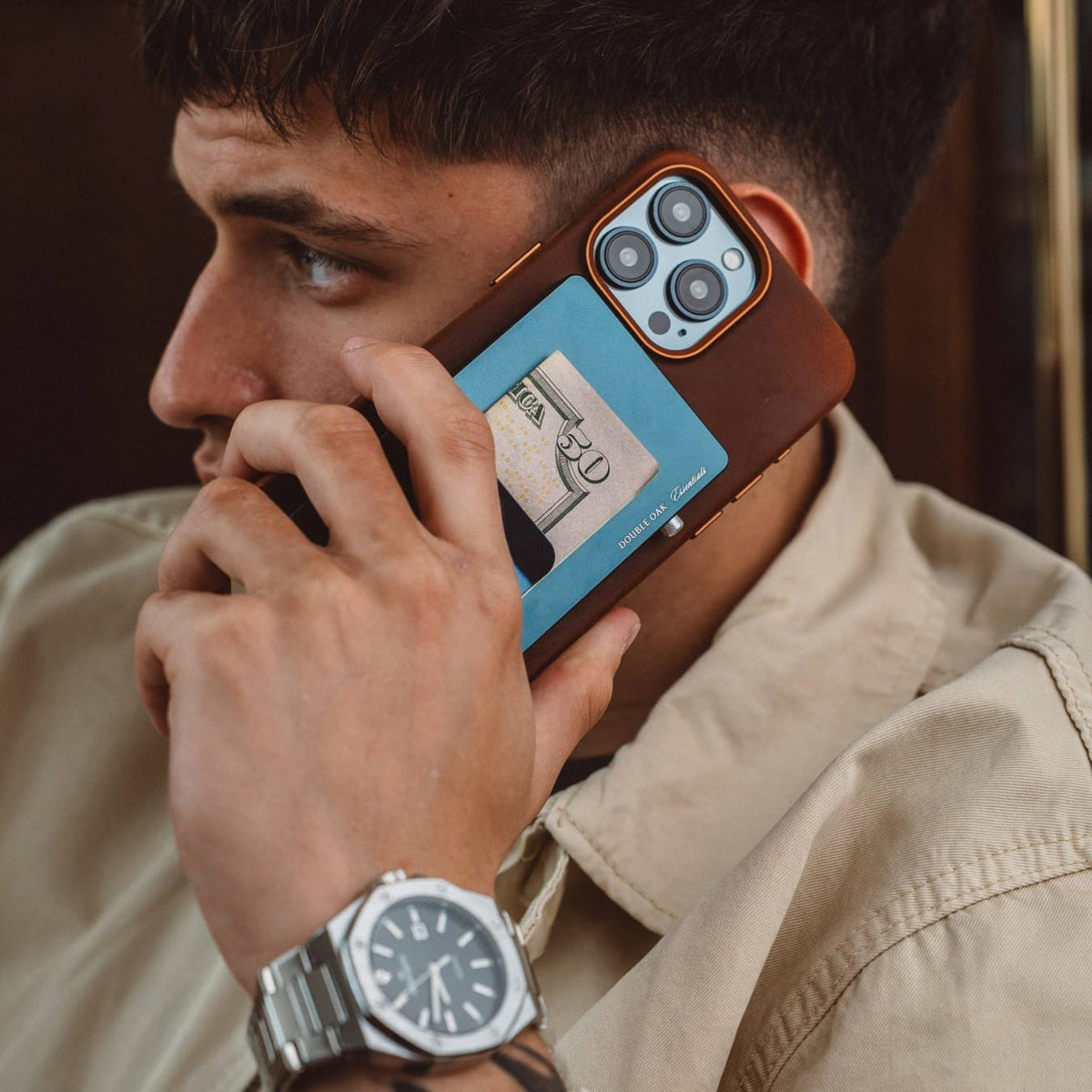 Blue pop-up cardholder with a payment card visible under a phone case.