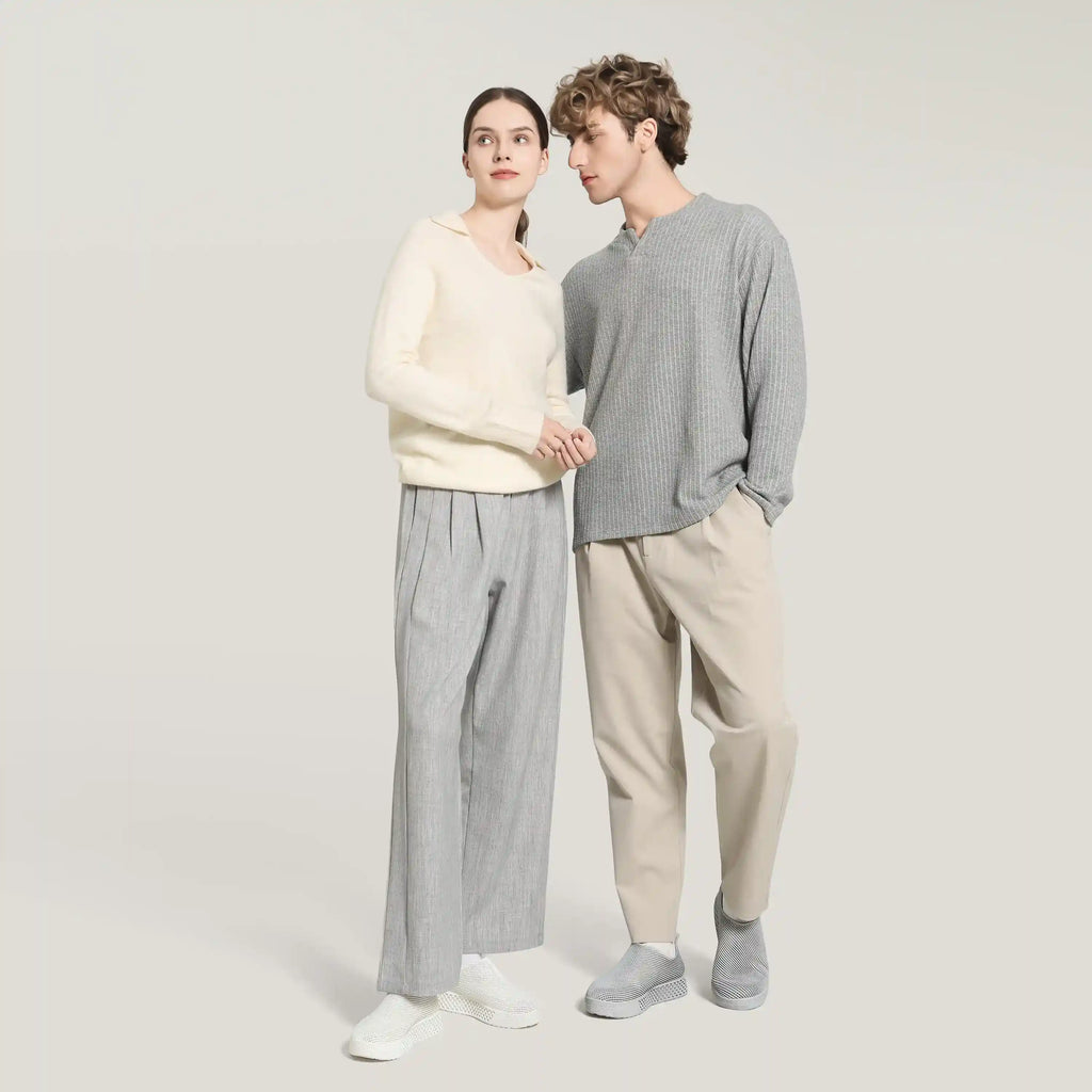 White 3D-printed slip-on sneakers on two models wearing light and gray outfits