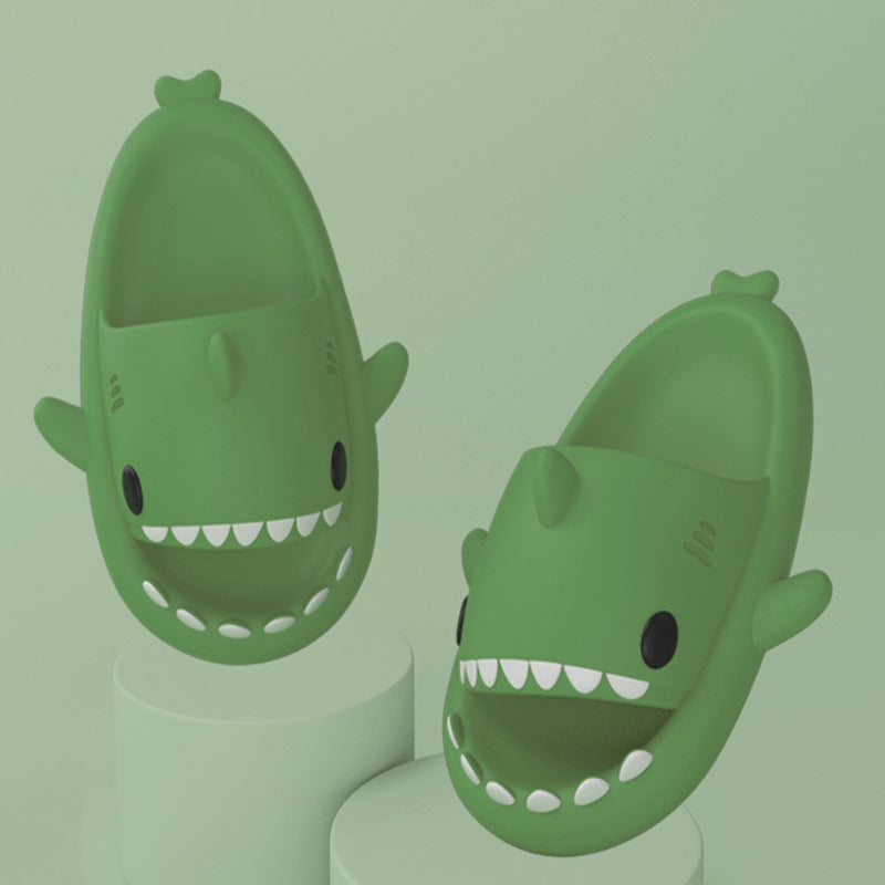 Green shark-shaped slide sandals shown upright, open toe with white tooth trim