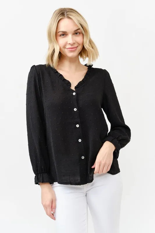 Black polka-dot button-front blouse with ruffle neckline and long sleeves