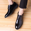 Men's black leather lace-up oxford dress shoes, glossy finish.