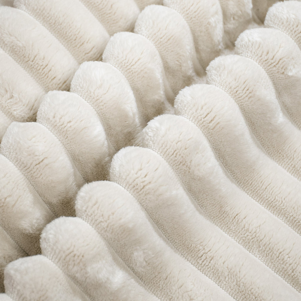 Close-up of white plush corduroy/flannel upholstery texture on the sofa seat
