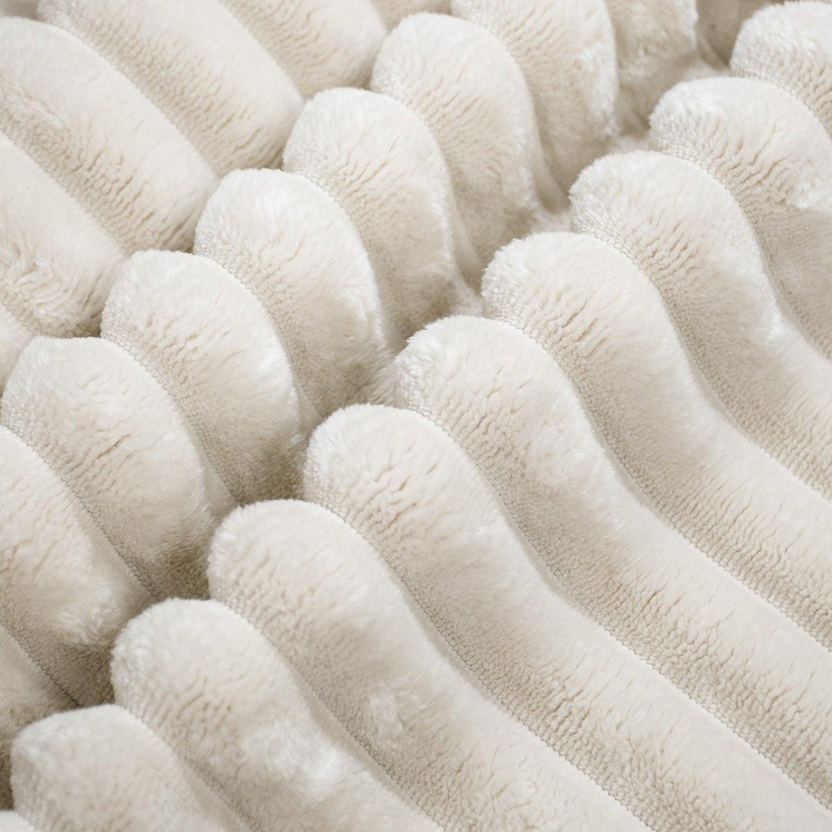 Close-up of white plush corduroy/flannel upholstery texture on the sofa seat