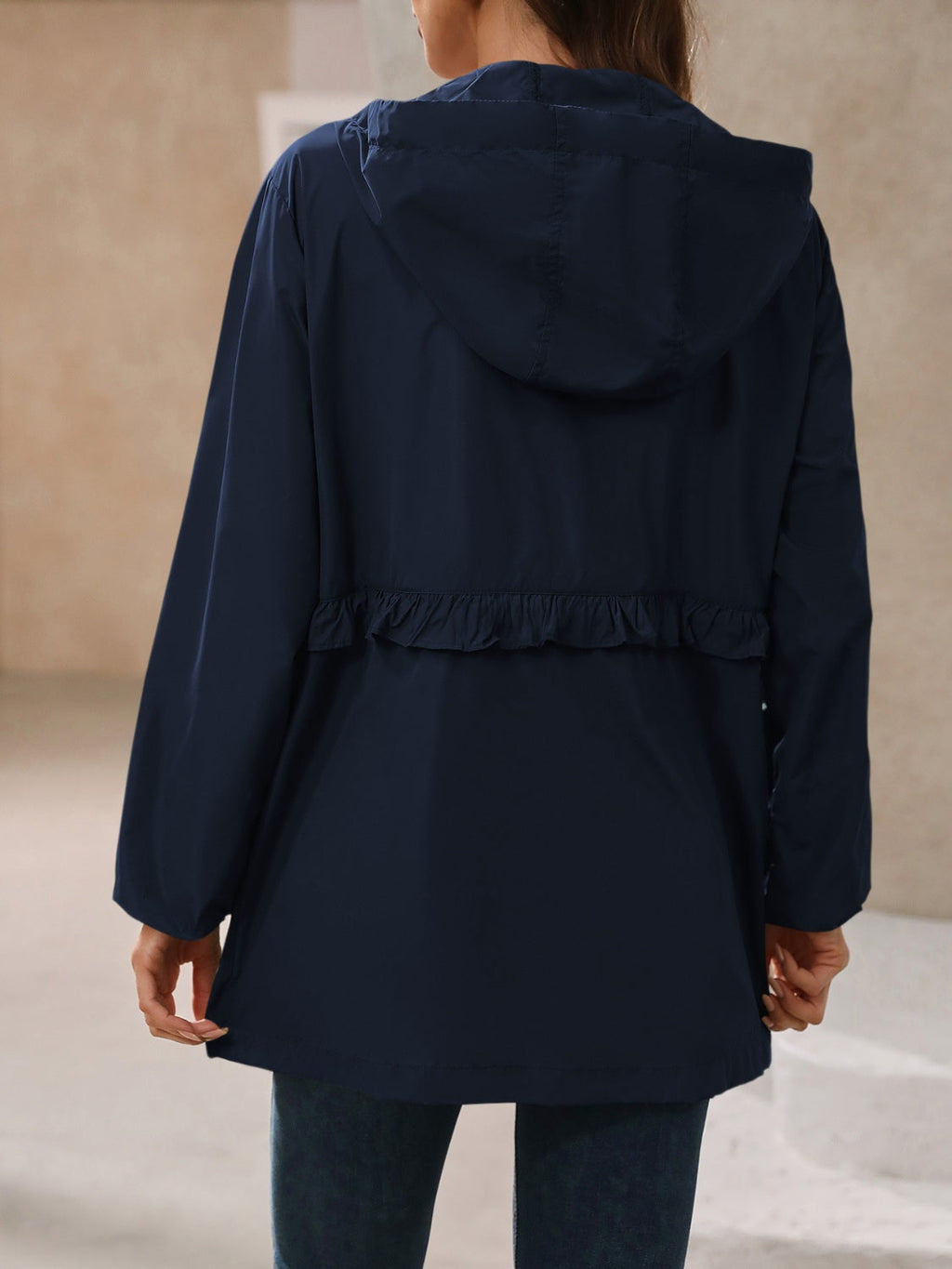 Navy hooded windbreaker jacket, back view with hood and gathered ruffle hem