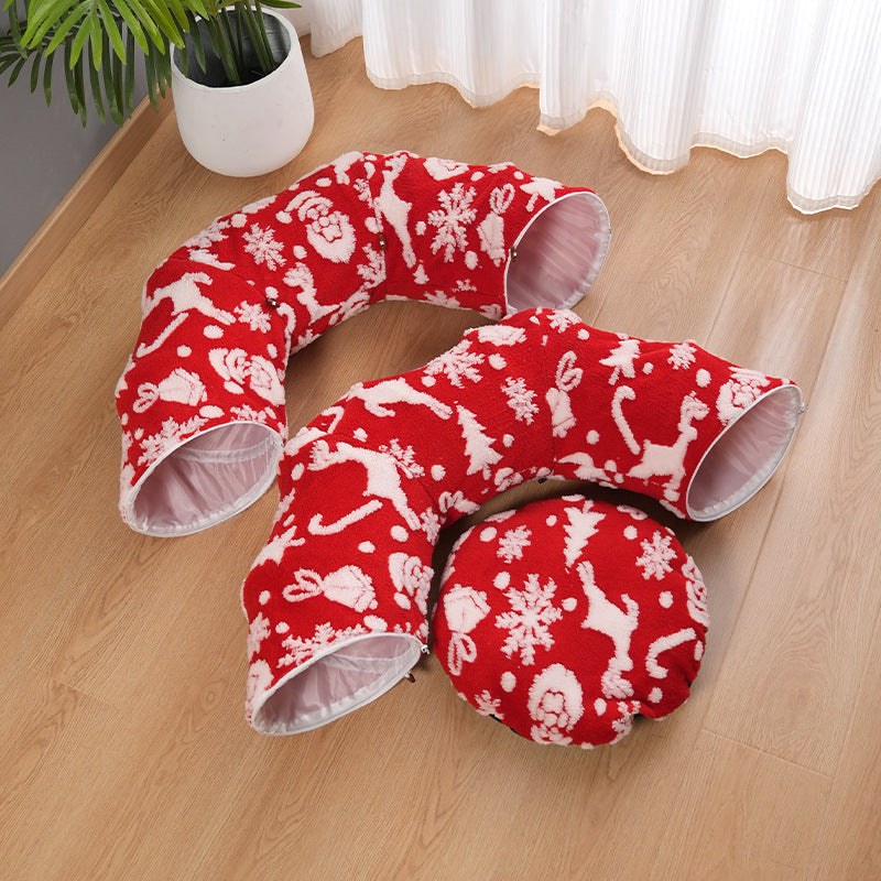 Red donut cat mattress with white snowflake pattern and side tunnel opening, plush fabric