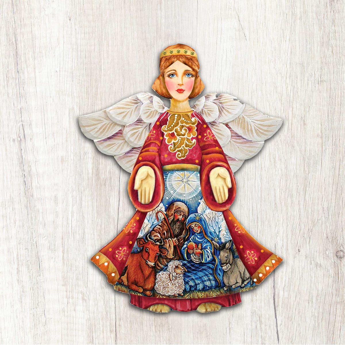 Nativity angel door decor: white feathered wings, red robe, ring handles over nativity scene