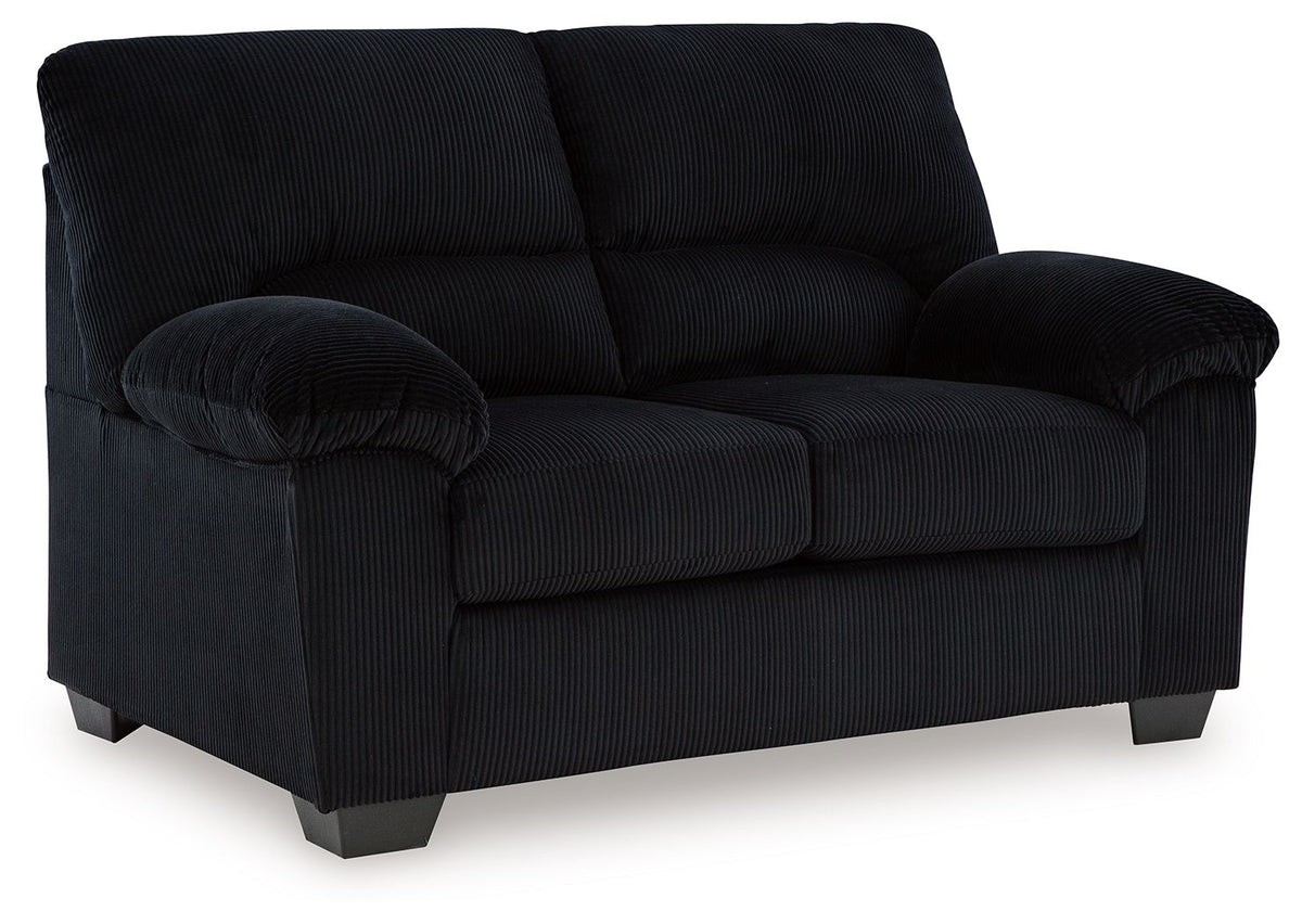 Upholstered sofa in dark fabric, side view with rolled arms and boxy back cushions