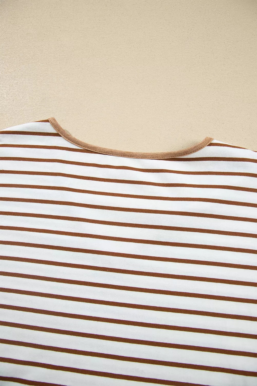 Striped top shoulder and neckline with camel contrast trim, close-up