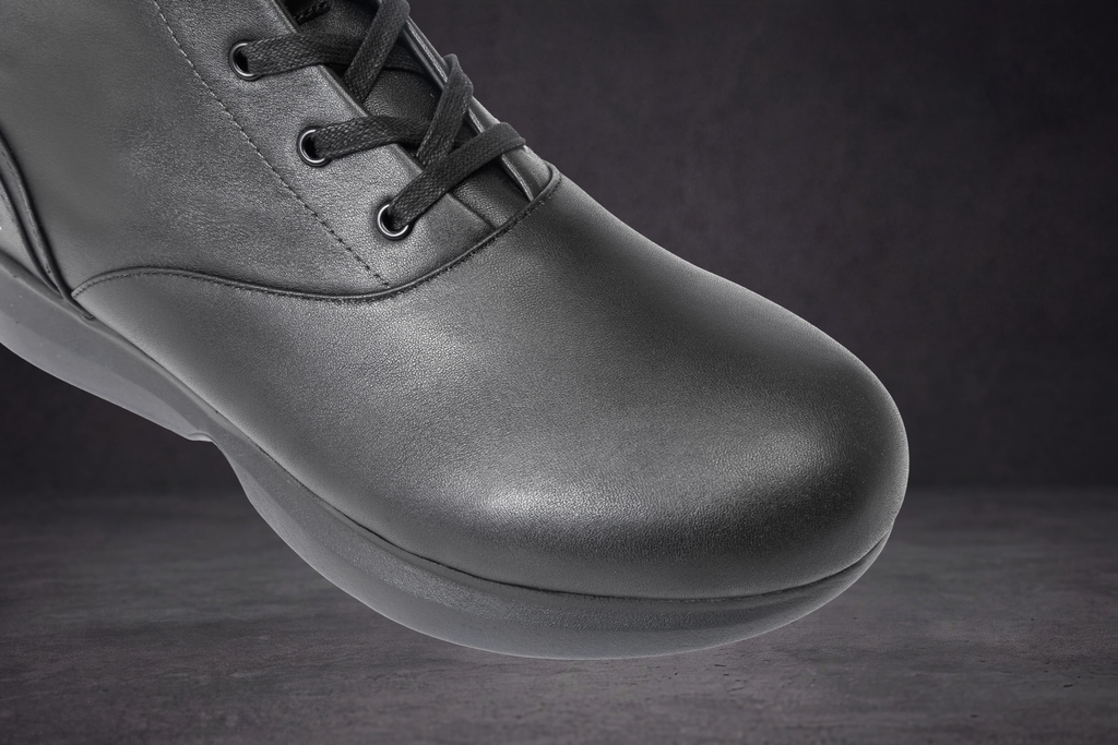 WOA sneaker toe and sole close-up, dark leather upper with lace front