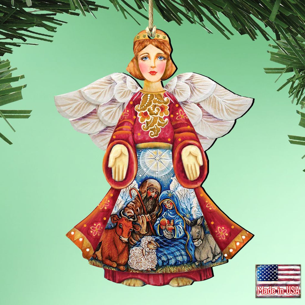 Nativity angel ornament hanging from a branch, with painted blue manger scene.
