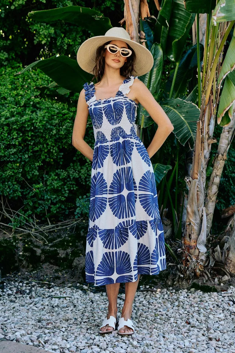 Back to front view of navy and white abstract print sleeveless midi dress with smocked bodice