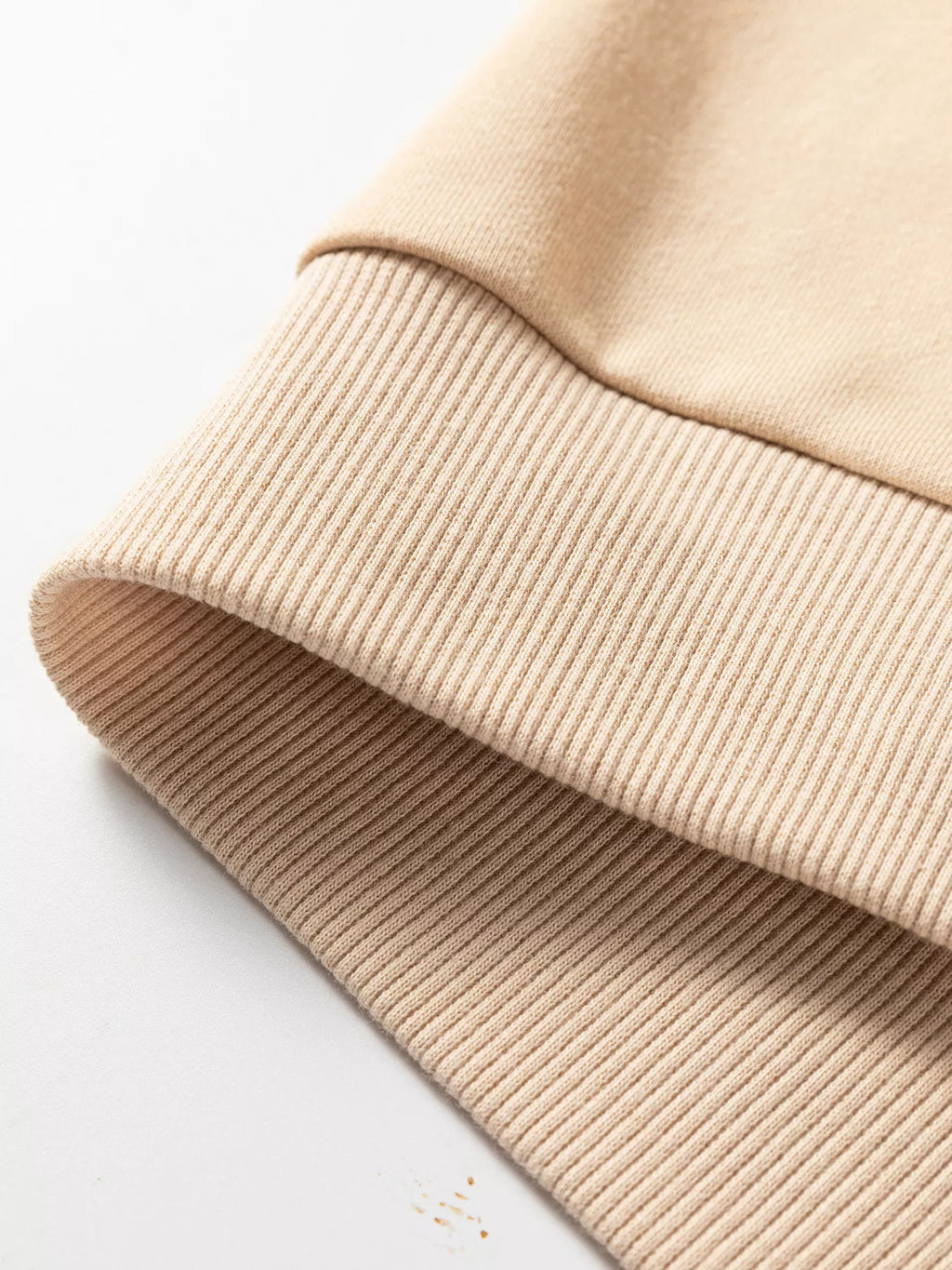 Beige ribbed sleeve cuff with textured knit detail