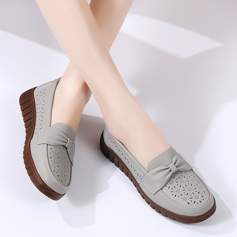 Women’s gray perforated flat loafers with bow detail and ridged rubber sole