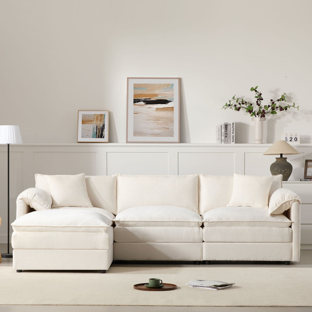 Beige modular sectional sofa with left chaise, wide arms, and plush seat cushions