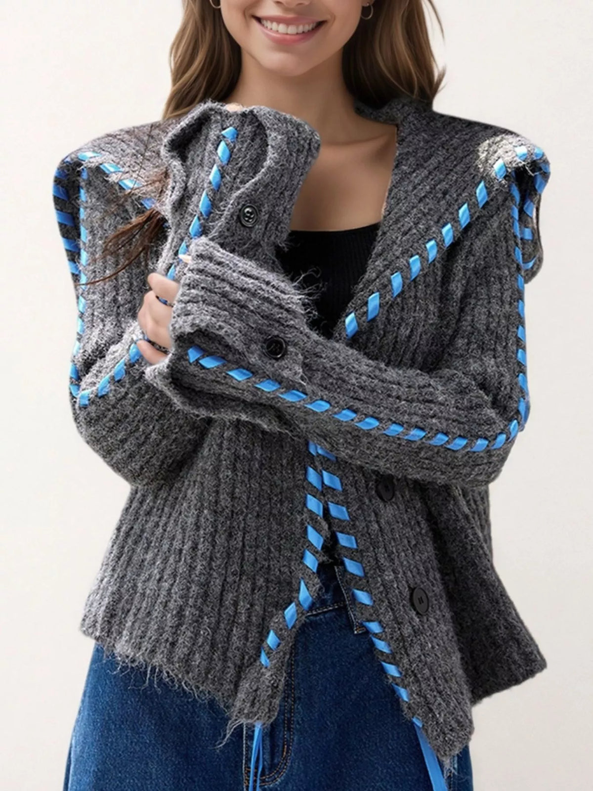 Gray ribbed knit open-front cardigan with blue ladder-stitch trim and button closure