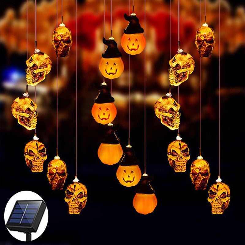 Solar LED wind chime with glowing skull and jack-o-lantern hanging ornaments