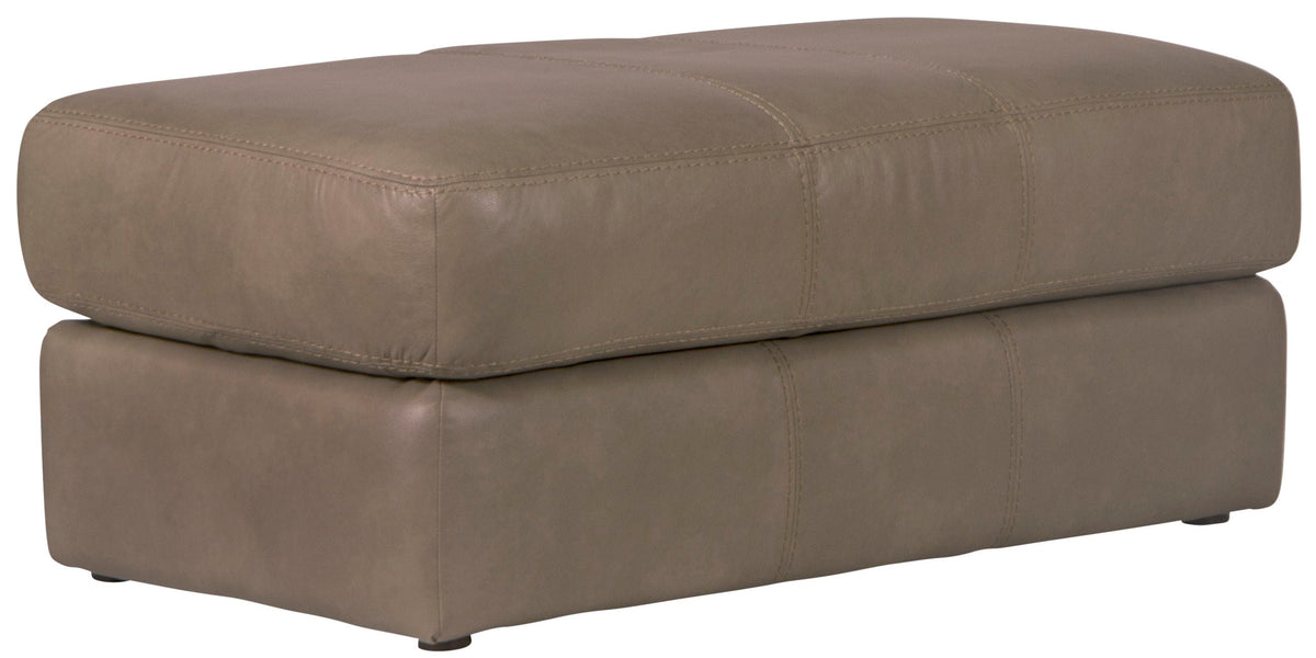 Putty leather ottoman with cushioned top and square base, stitched seams.